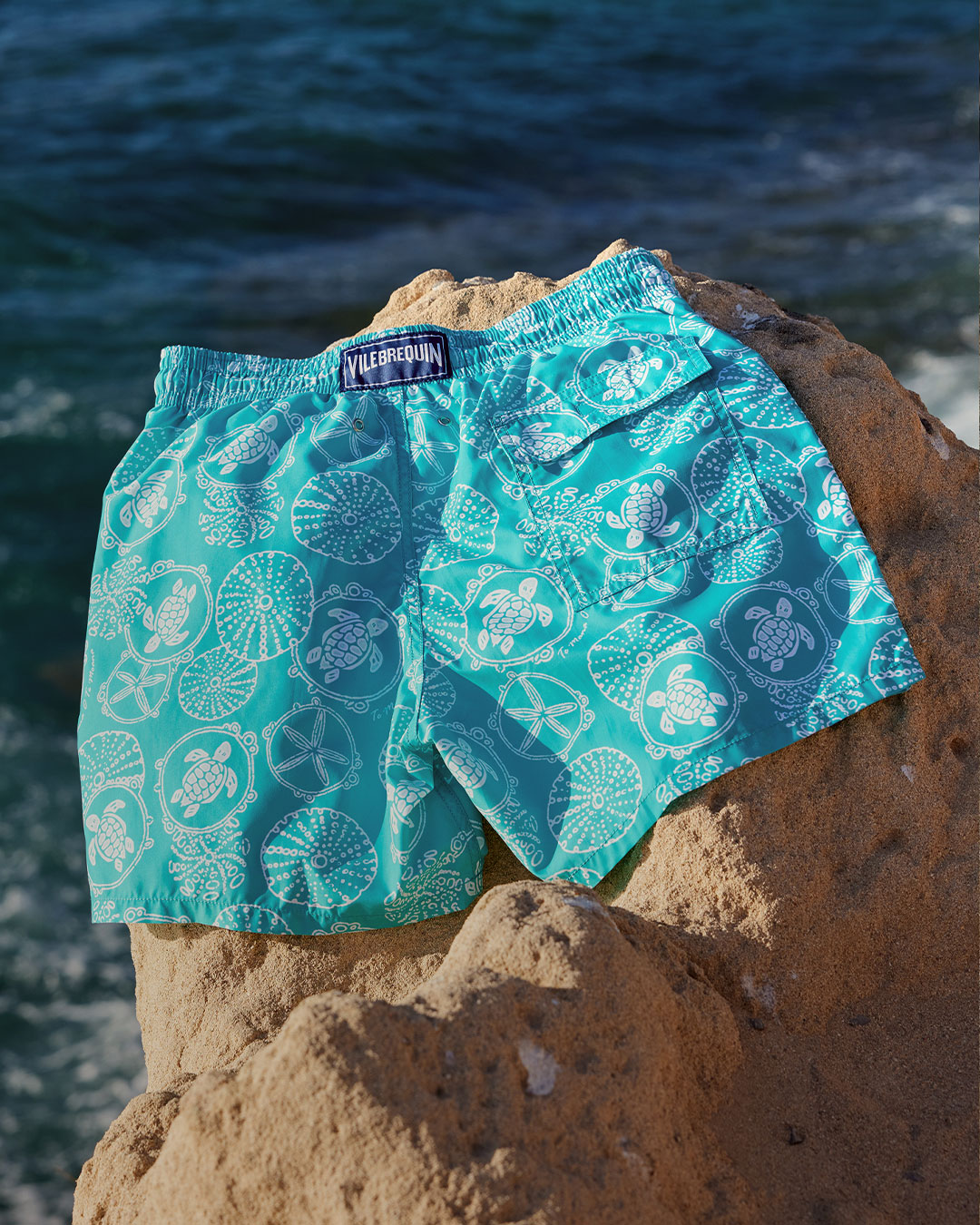 Blue swimsuit placed on a rock.